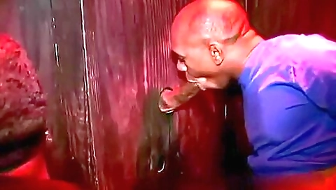 Brunette is riding a big black cock in a glory hole