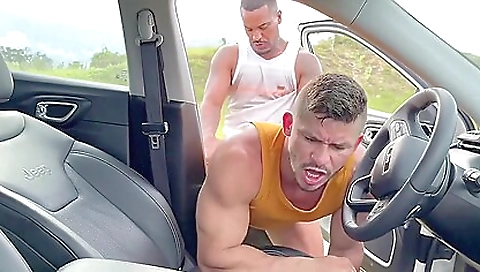 A guy gets his large dick deepthroated by a busty brunette