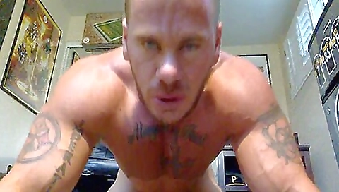 Tattooed guy talks with his girl and tongue in his mouth